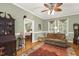 Inviting living room with hardwood floors, a ceiling fan, and access to a bedroom, perfect for relaxation and comfort at 6517 Whitted Rd, Fuquay Varina, NC 27526