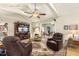 A cozy living room with hardwood floors, ceiling fan, and comfortable seating arrangements at 6517 Whitted Rd, Fuquay Varina, NC 27526