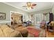 Bright living room with hardwood floors, traditional furnishings, an open doorway to other living areas, and ample natural light at 6517 Whitted Rd, Fuquay Varina, NC 27526