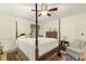 Bedroom featuring a four-poster bed, a ceiling fan, and a comfortable seating area at 6517 Whitted Rd, Fuquay Varina, NC 27526