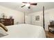 Bedroom with a four-poster bed, wooden floors, and an ensuite bathroom with double doors at 6517 Whitted Rd, Fuquay Varina, NC 27526