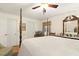 Spacious bedroom with a four-poster bed, wooden floors, and comfortable seating by the windows at 6517 Whitted Rd, Fuquay Varina, NC 27526