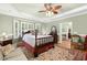 Spacious bedroom with tray ceilings, bay window, sitting area, and hardwood flooring at 6517 Whitted Rd, Fuquay Varina, NC 27526