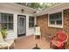 Outdoor back porch with white and brick walls and space for patio furniture at 6517 Whitted Rd, Fuquay Varina, NC 27526