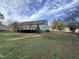 A lovely green home with a nice wooden deck in the backyard at 803 Flat Rock Church Rd, Louisburg, NC 27549