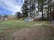 Spacious backyard with a storage building, offering ample room for recreation and relaxation at 803 Flat Rock Church Rd, Louisburg, NC 27549