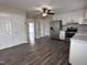 Open-concept kitchen featuring white cabinets, stainless steel refrigerator, and seamless flow to other living areas at 803 Flat Rock Church Rd, Louisburg, NC 27549