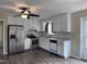 Well-lit kitchen with stainless steel appliances, white cabinets, and wood-look floors at 803 Flat Rock Church Rd, Louisburg, NC 27549