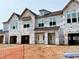 Exterior view of townhomes under construction, with visible framing, windows, and doors at 83 Ripple Way # 215, Clayton, NC 27520