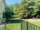 Spacious backyard featuring a patio area, lush lawn, and a wrought iron fence at 8729 Valentine Ct, Raleigh, NC 27613
