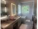 Bright bathroom with double vanity, soaking tub, and large window at 8729 Valentine Ct, Raleigh, NC 27613