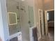 Modern bathroom features a glass shower, tiled walls, and decorative mirror at 8729 Valentine Ct, Raleigh, NC 27613