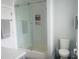 Bright bathroom featuring a glass-enclosed shower with built-in shelving for added convenience at 8729 Valentine Ct, Raleigh, NC 27613