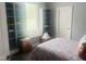 This bedroom features hardwood floors, a bed with colorful sheets, and built-in bookshelves at 8729 Valentine Ct, Raleigh, NC 27613