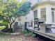 Lovely deck with grill, greenery, and outdoor seating adds charm to this backyard retreat at 8729 Valentine Ct, Raleigh, NC 27613