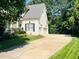 Exterior elevation with driveway, basketball hoop, and three-car garage at 8729 Valentine Ct, Raleigh, NC 27613