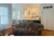 Living room features a kitchen view, plush furnishings, and large windows with natural lighting at 8729 Valentine Ct, Raleigh, NC 27613