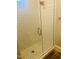 Modern tiled shower features white subway tile, glass door, and mosaic tile flooring at 8729 Valentine Ct, Raleigh, NC 27613