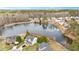 An aerial view of a beautiful pond surrounded by houses and trees at 930 Pristine Ln, Rolesville, NC 27571