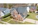 An aerial view of a stunning property, showcasing its well-manicured lawn and serene lake views at 930 Pristine Ln, Rolesville, NC 27571