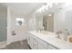 Bright bathroom featuring double sinks, a large mirror, and a soaking tub at 930 Pristine Ln, Rolesville, NC 27571