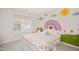 bedroom with cute rainbow mural, window, and colorful bed at 930 Pristine Ln, Rolesville, NC 27571