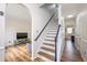 Inviting entryway with hardwood floors, staircase, and a view into the living room at 930 Pristine Ln, Rolesville, NC 27571
