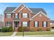 Beautiful two-story brick home with black shutters and manicured landscaping at 930 Pristine Ln, Rolesville, NC 27571