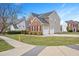 Charming two-story home with brick and siding, a well-manicured lawn, and a two-car garage at 930 Pristine Ln, Rolesville, NC 27571
