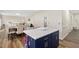 Kitchen island with white countertop, navy cabinets, and seating for two at 930 Pristine Ln, Rolesville, NC 27571