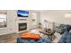 Cozy living room with a fireplace, TV, and comfortable blue couch at 930 Pristine Ln, Rolesville, NC 27571