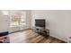 Bright room showcasing wood floors, a TV stand and ample sunlight from a large window at 930 Pristine Ln, Rolesville, NC 27571