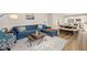 Open concept living room boasts a sofa, dining area, and access to the kitchen at 930 Pristine Ln, Rolesville, NC 27571