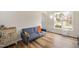Bright living room with a comfortable blue sofa, hardwood floors, and lots of natural light at 930 Pristine Ln, Rolesville, NC 27571
