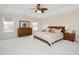 Spacious main bedroom with neutral carpet, a trey ceiling, and windows that let in ample natural light at 930 Pristine Ln, Rolesville, NC 27571