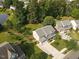 Gorgeous aerial view of home, with lush, mature trees, well-manicured lawn, and proximity to a lake at 947 Middle Ground Ave, Rolesville, NC 27571