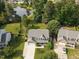 Attractive aerial view of a home featuring a well-manicured lawn and mature trees near a tranquil lake at 947 Middle Ground Ave, Rolesville, NC 27571