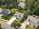 Aerial view of beautiful home with well-maintained lawn, lush trees, and proximity to a serene lake at 947 Middle Ground Ave, Rolesville, NC 27571