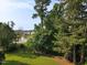 Picturesque backyard with mature trees, pond view, and lush green lawn at 947 Middle Ground Ave, Rolesville, NC 27571