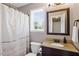 Bathroom with granite countertops, a framed mirror, a window, and a shower curtain at 947 Middle Ground Ave, Rolesville, NC 27571