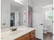 Bathroom with a double sink, and multiple white doors at 947 Middle Ground Ave, Rolesville, NC 27571