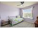 Light purple bedroom featuring a metal-frame twin bed and a window with bright natural light at 947 Middle Ground Ave, Rolesville, NC 27571