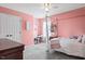 Bright bedroom features pink walls, carpet, and canopy bed frame with desk and shelf at 947 Middle Ground Ave, Rolesville, NC 27571