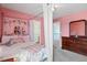 Pink bedroom with four poster bed, dresser, and lots of natural light at 947 Middle Ground Ave, Rolesville, NC 27571