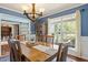 Dining room boasting a large window for natural light and a stylish chandelier above the table at 947 Middle Ground Ave, Rolesville, NC 27571