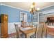 Inviting dining room with wood table, chandelier, and accents, perfect for Gathering meals and entertaining guests at 947 Middle Ground Ave, Rolesville, NC 27571