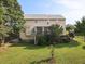 Back exterior of the home showcasing a deck, screened in porch, and spacious yard at 947 Middle Ground Ave, Rolesville, NC 27571