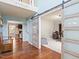 Open foyer with hardwood floors, barn doors, and views to the living room and office at 947 Middle Ground Ave, Rolesville, NC 27571