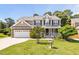 Charming two-story home featuring neutral siding, a brick-accented garage, and a well-manicured lawn at 947 Middle Ground Ave, Rolesville, NC 27571