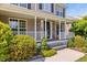 Inviting front porch with white railings, stone columns, and well-maintained landscaping at 947 Middle Ground Ave, Rolesville, NC 27571